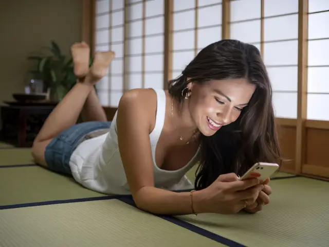 woman relaxing tatami smartphone