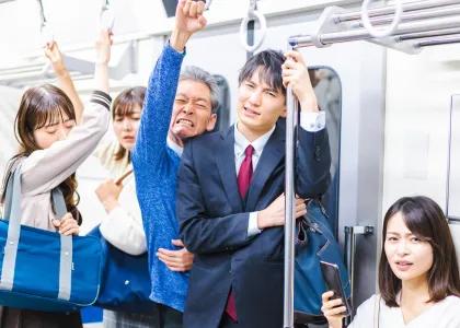 Japanese business workers packed on a train while commuting to work.