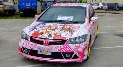 A pink Itasha in an empty parking lot.