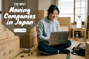Happy woman on laptop connected to home WiFI amidst moving boxes in Japan.