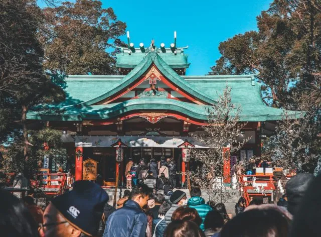 a crowd at a Japanese shrine