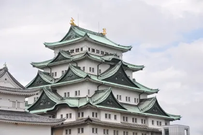 Slightly diagonal view looking up at mufti-tiered main keep of Nagoya Castle