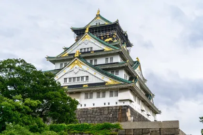 Low angle of Osaka Castle with vibrant golden features