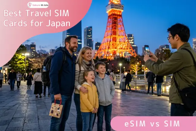 Family poses for a phot in front of Tokyo Tower at night while a photographer takes their picture with a smartphone, with city lights in the background.
