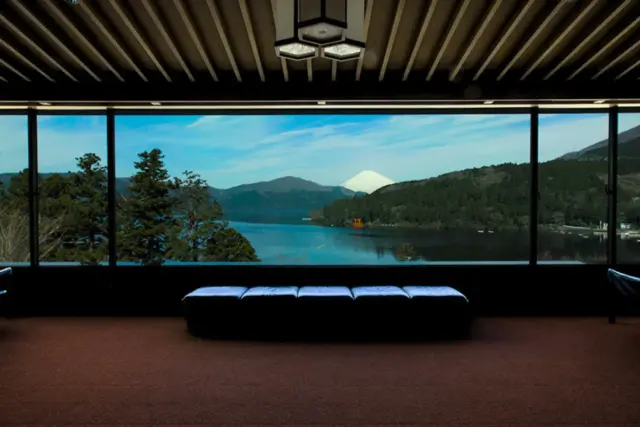 Breathtaking view of Lake Ashi and Mt. Fuji through a large panoramic lounge window