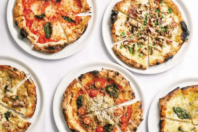 Five types of pizza decorated with various toppings, ranging from basil and mushrooms to tomatoes, cheese, anchovies, and honey.