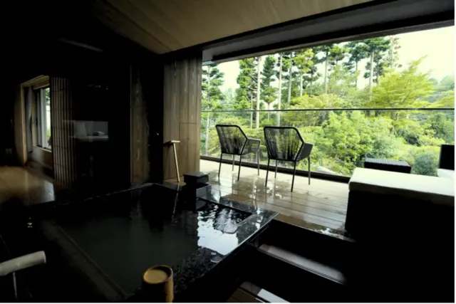 Private in-room onsen with scenic view of the natural mountain greenery