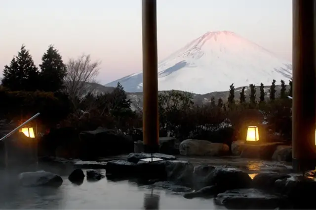 Open-air Hakone Onsen with an evening view of Mt. Fuji