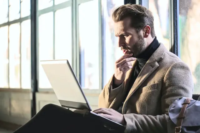 A traveler researching hiking in Japan on a laptop