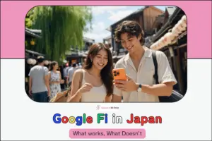 A young couple smiling together while checking a smartphoneon a lantern-lined Kyoto street.