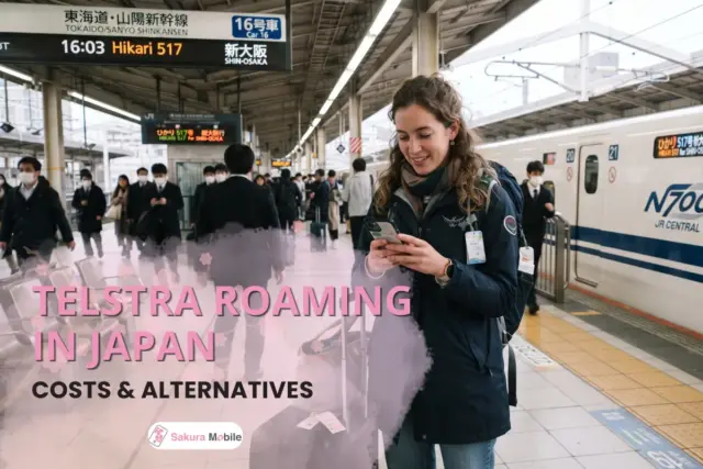A traveler with a suitcase and backpack uses her smartphone on the platform of a Tokyo train station with a Shinkansen in the background.